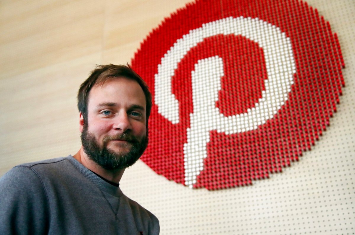 FILE - In this Oct. 11, 2018, file photo, Evan Sharp, Pinterest co-founder and chief product officer, poses for a photo, standing beside a wall of pegs symbolizing the company logo at Pinterest headquarters in San Francisco.
