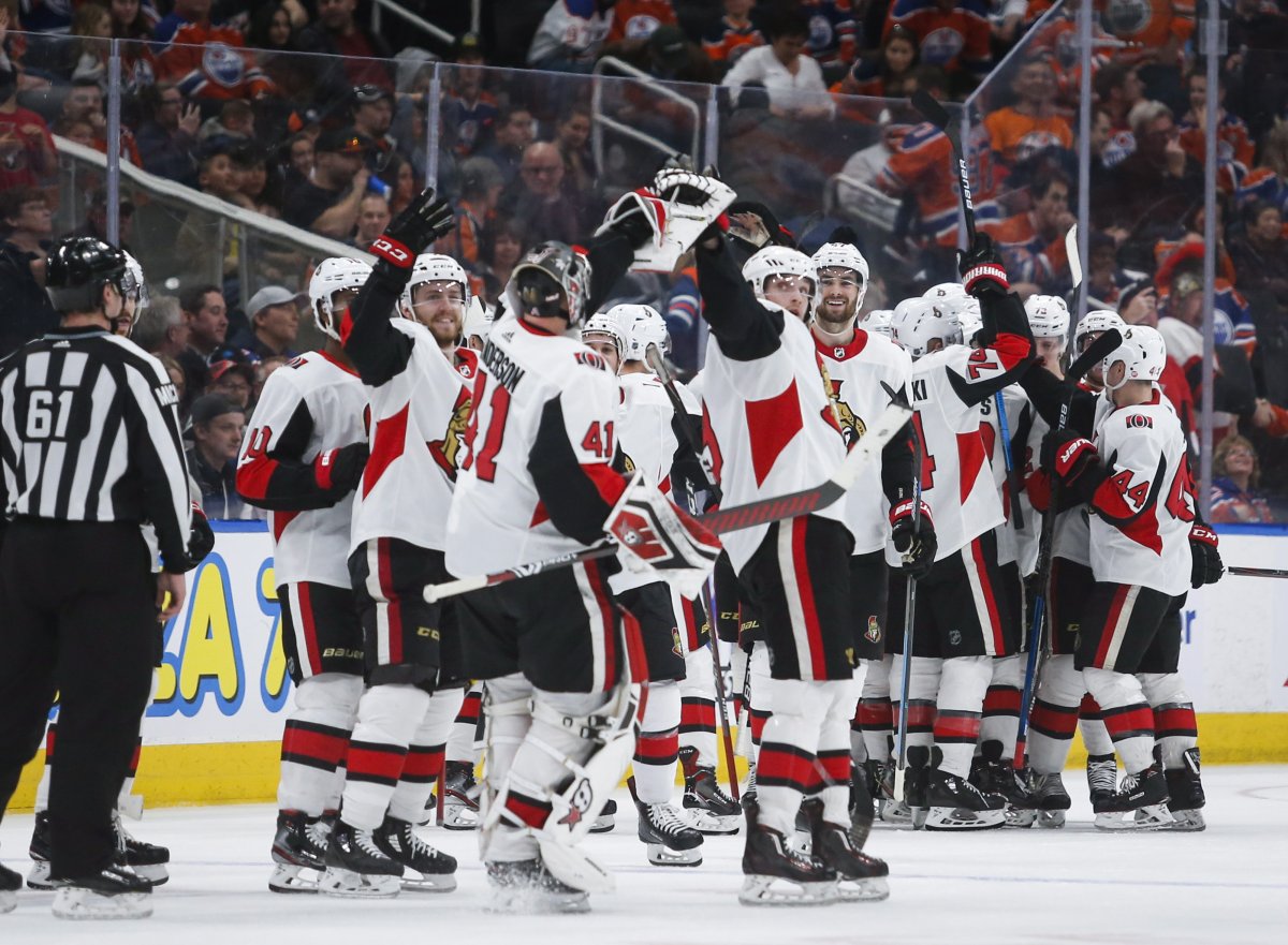 Ottawa Senators goalie Craig Anderson (41) celebrates his team's overtime win with teammates following overtime NHL hockey action against the Edmonton Oilers, in Edmonton, Saturday, March 23, 2019. 