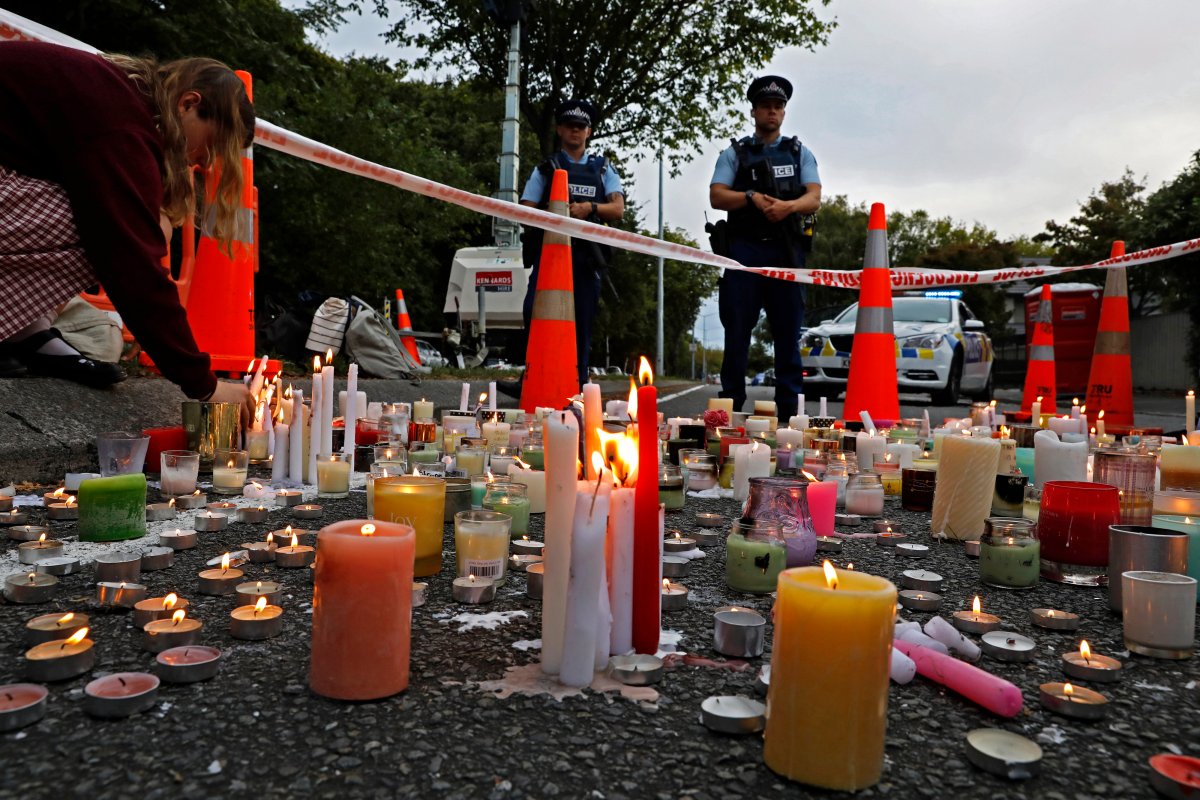 FILE - In this March 18, 2019, file photo, a student lights candle during a vigil to commemorate victims of March 15 shooting, outside the Al Noor mosque in Christchurch, New Zealand.