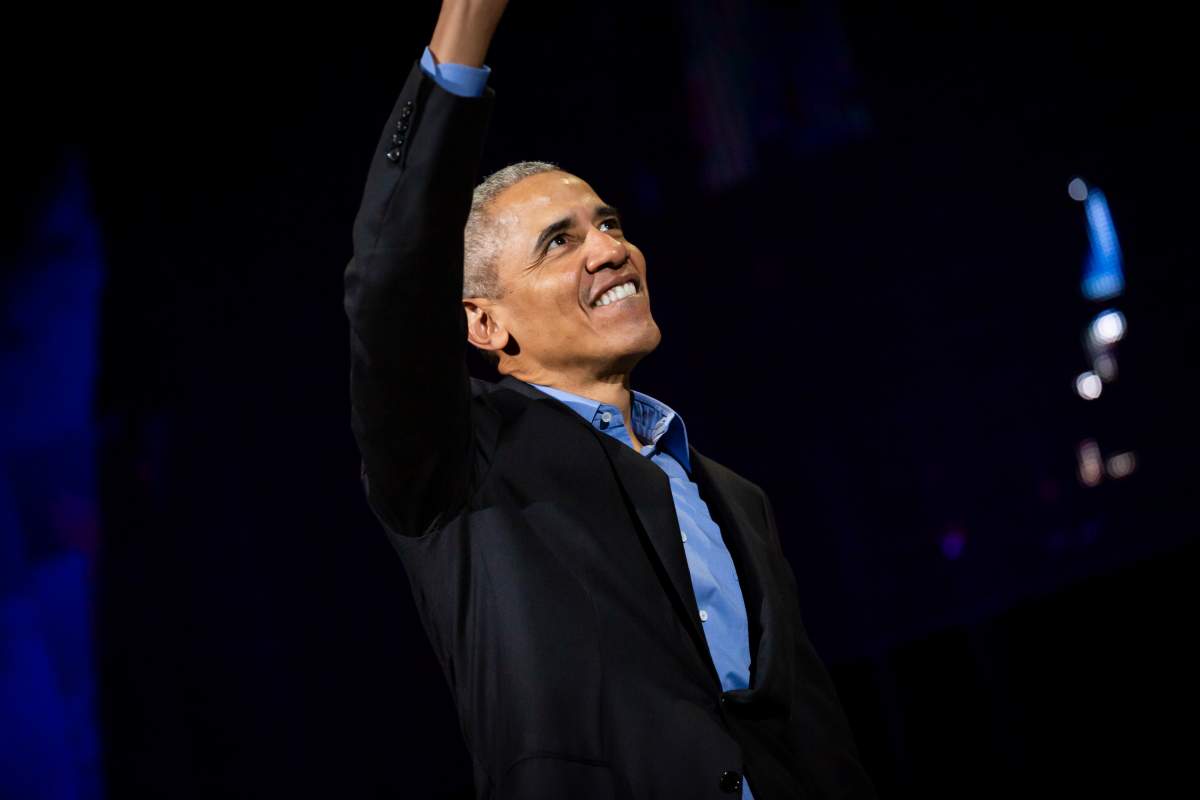 Barack Obama enters the stage at the Scotiabank Saddledome in Calgary on March 5, 2019.