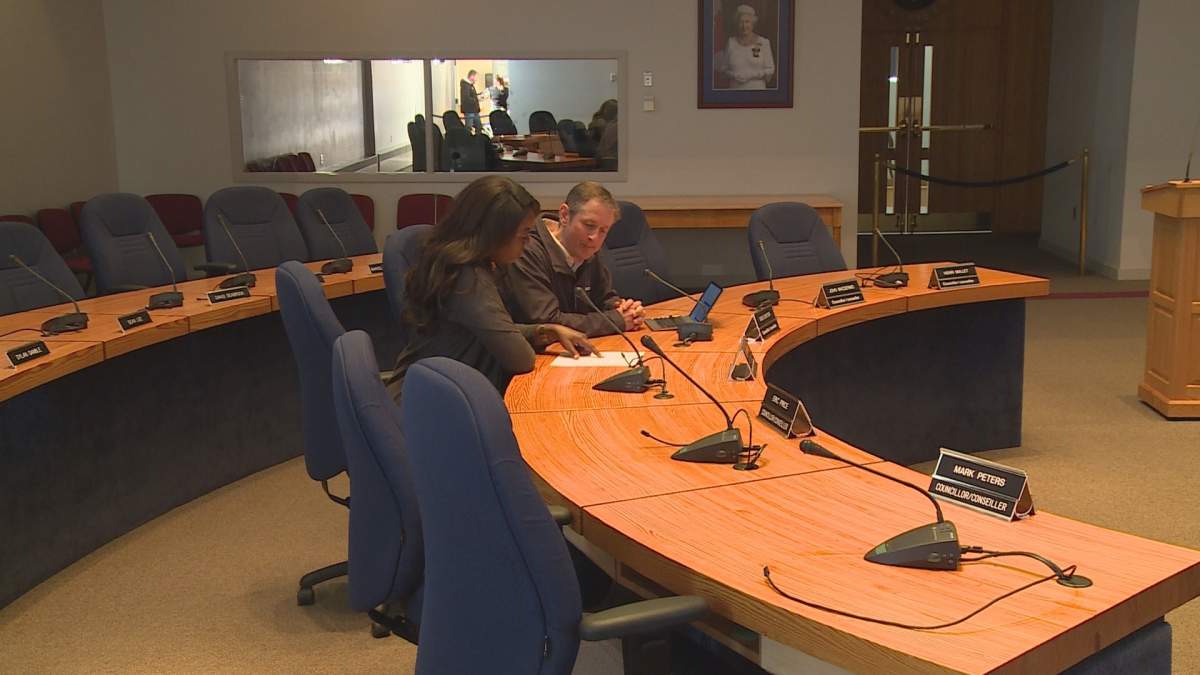 Greg Ericson a Fredericton City Councilor explains the changes to Megan Yamoah