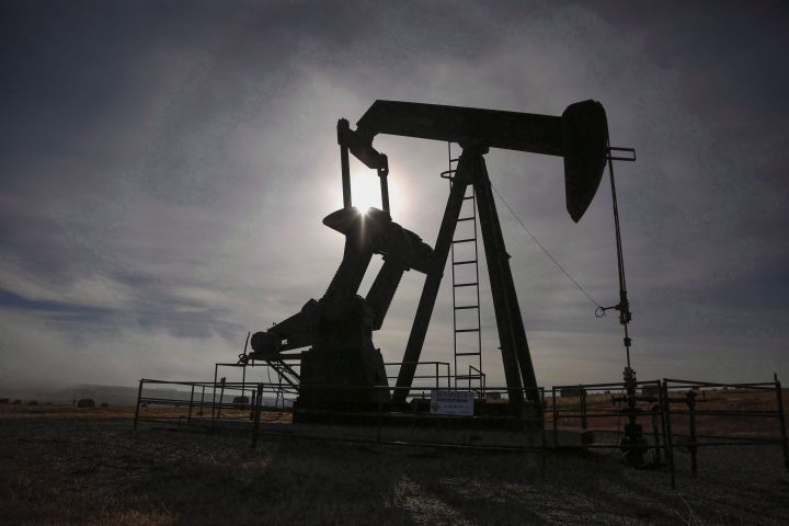 A pumpjack works at a well head on an oil and gas installation near Cremona, Alta., Saturday, Oct. 29, 2016. Statistics Canada says capital spending to extract oil and gas will fall for a fourth straight year in Canada in 2018. 