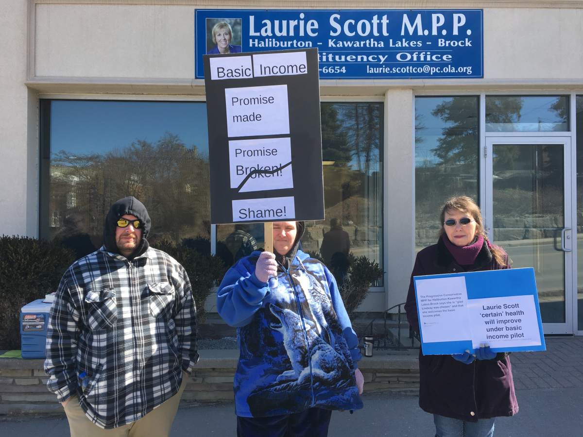 Protesters gather outside MPP Laurie Scott's office in Lindsay to express concerns about the province ending the basic income pilot project. Monday was the last day for the project.