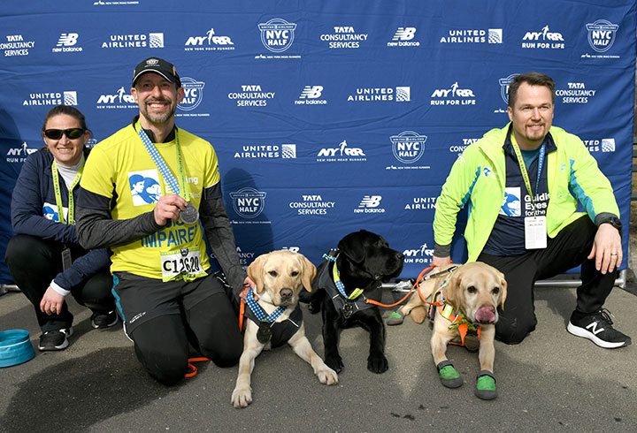 Guiding Eyes for the Blind President and CEO, Thomas Panek, runs the first ever 2019 United Airlines NYC Half Marathon led completely by guide dogs, Waffle, Westley and Gus on March 17, 2019 in New York City.