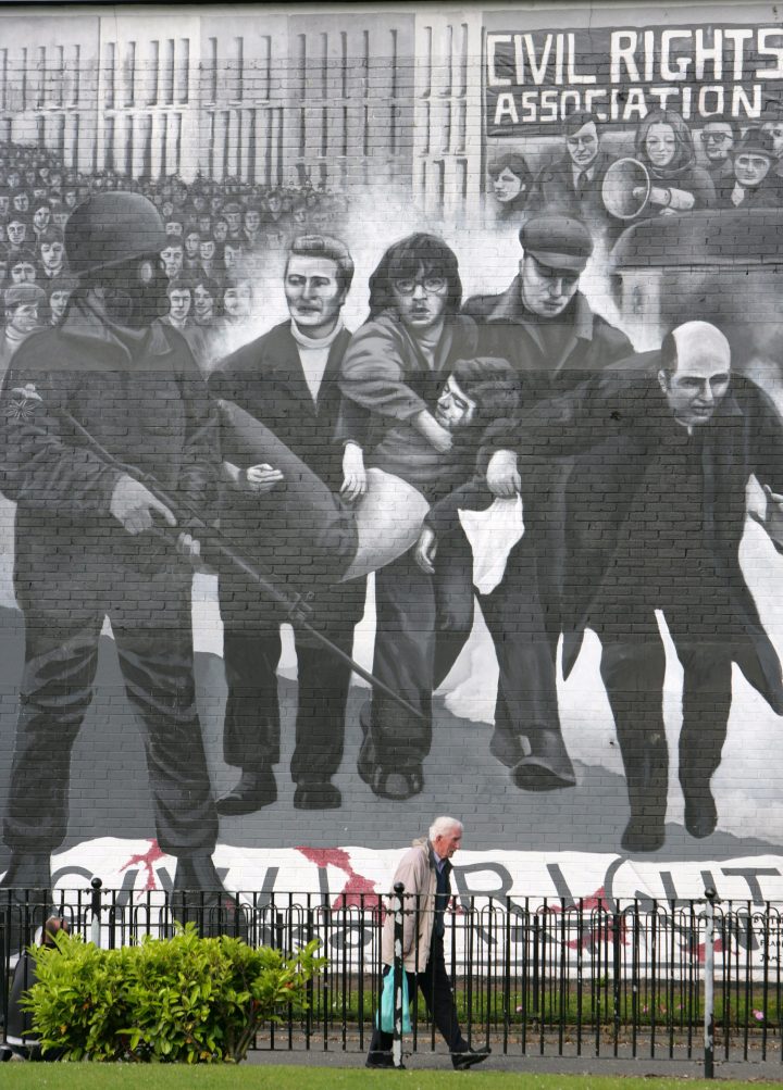 This file photo shows a man walking past a Bloody Sunday mural in the Bogside, Londonderry, Northern Ireland, on June 15, 2010.