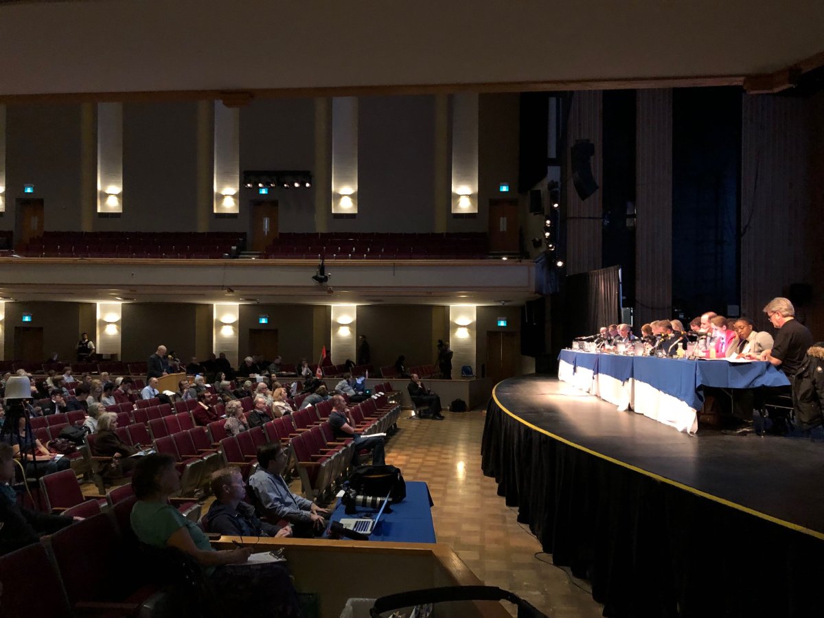 London city councillors listen from the stage of Centennial Hall as members of the public weigh in on which transit projects should be prioritized by the city.