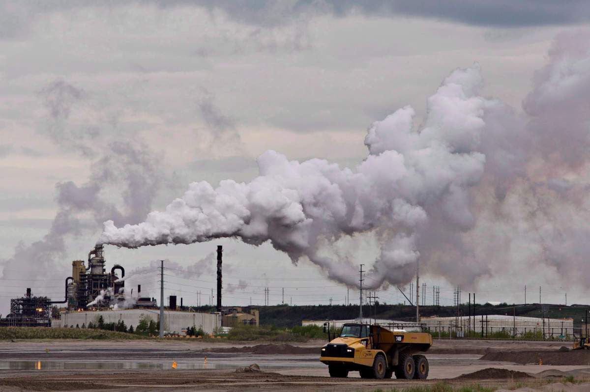 A dump truck works near the Syncrude oil sands extraction facility near the city of Fort McMurray, Alta., on June 1, 2014. 