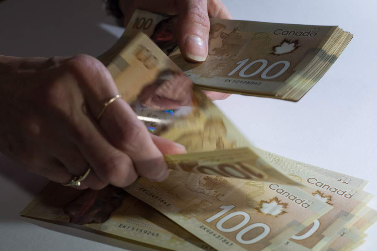 Canadian $100 bills are counted in Toronto, Feb. 2, 2016.