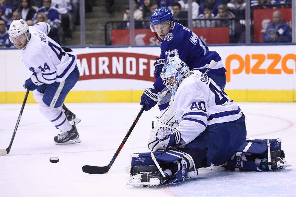 Toronto Maple Leafs goaltender Garret Sparks (40) makes a stop on Tampa Bay Lightning left wing Adam Erne (73) as defenceman Morgan Rielly (44) looks on during second period NHL hockey action in Toronto on Monday, March 11, 2019. THE CANADIAN PRESS/Cole Burston.