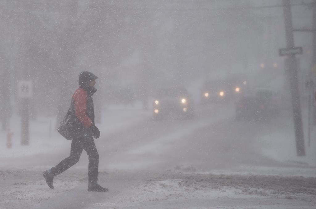 A pedestrian walks through a snow storm in Halifax on Thursday, March 8, 2018.