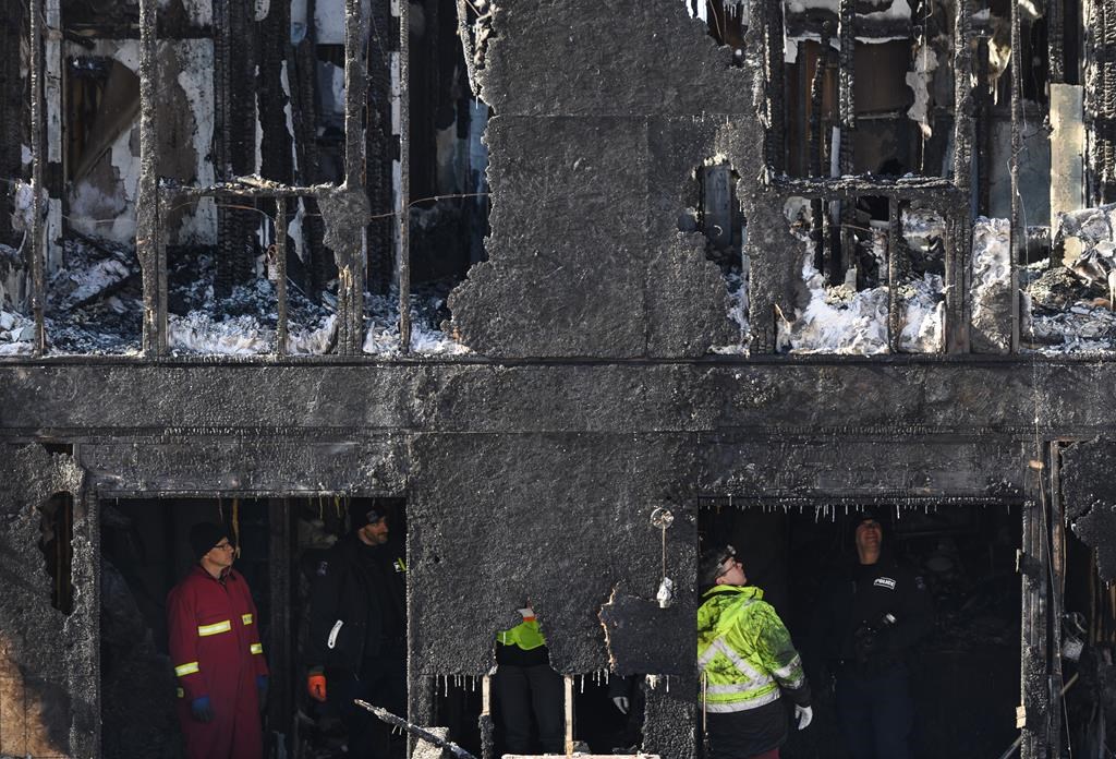Police and firefighters investigate at the scene of a fatal house fire in the Spryfield community in Halifax on Tuesday, February 19, 2019.