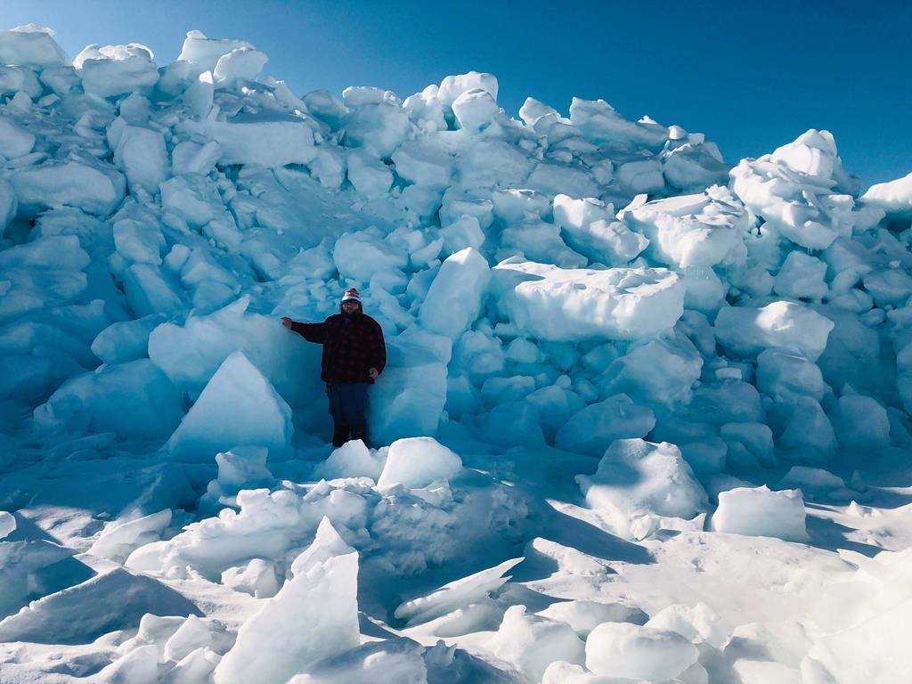 Brendon Gould stands by a wall of ice near Port au Choix, N.L. in this recent handout photo.