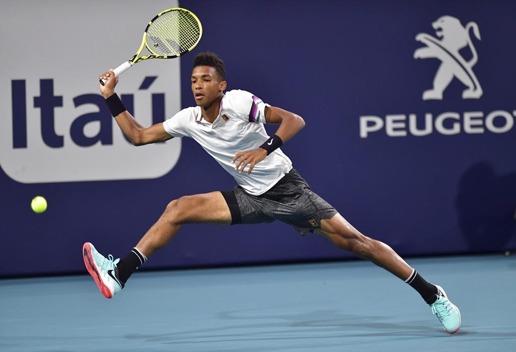 Felix Auger-Aliassime, of Canada, runs down a shot from Borna Coric, of Croatia, during the quarterfinals of the Miami Open tennis tournament Wednesday, March 27, 2019, in Miami Gardens, Fla. Canada's Felix Auger-Aliassime made history at the Miami Open on Wednesday night. THE CANADIAN PRESS/AP-Jim Rassol.