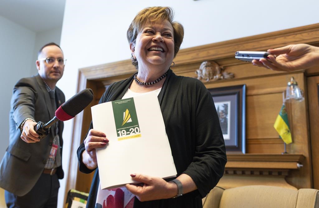 Finance Minister Donna Harpauer speaks to media at the reveal of her budget shoes at the Legislative Building in Regina on Monday, March 18, 2019.