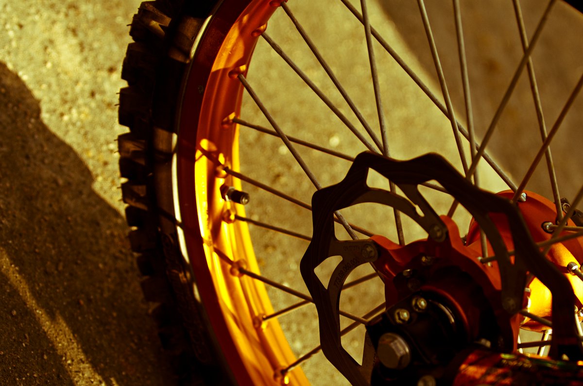 Close-up view of motocross bike wheel.