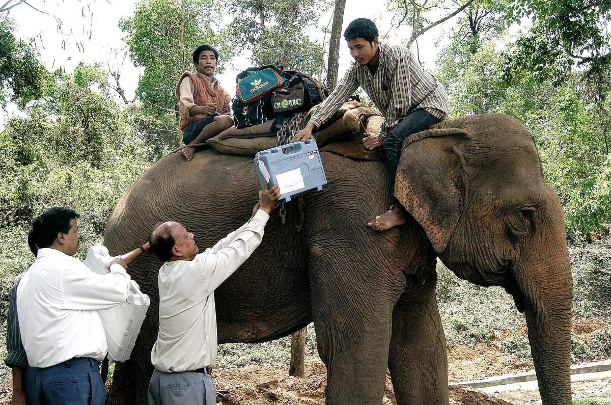 Nortap, India: Indian election officials load electronic voting machines onto an elephant leaving for polling stations of the Guwahati constituency on the eve of national elections in Nortap, Assam state, April 19, 2004.