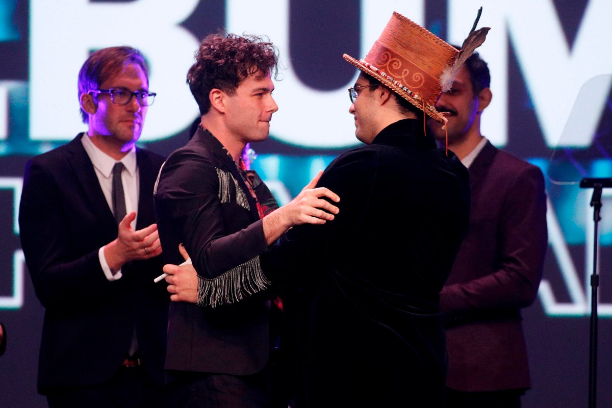 Max Kerman (L) of Arkells hugs Jeremy Dutcher after the Arkells won the 'Rock Album of the Year' during the Juno Awards Gala in London, on March 17, 2019.