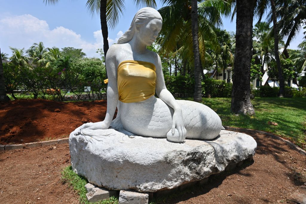 This picture taken at the Ancol amusement park in Jakarta on March 26, 2019 shows a statue of a mermaid with golden tube tops. 