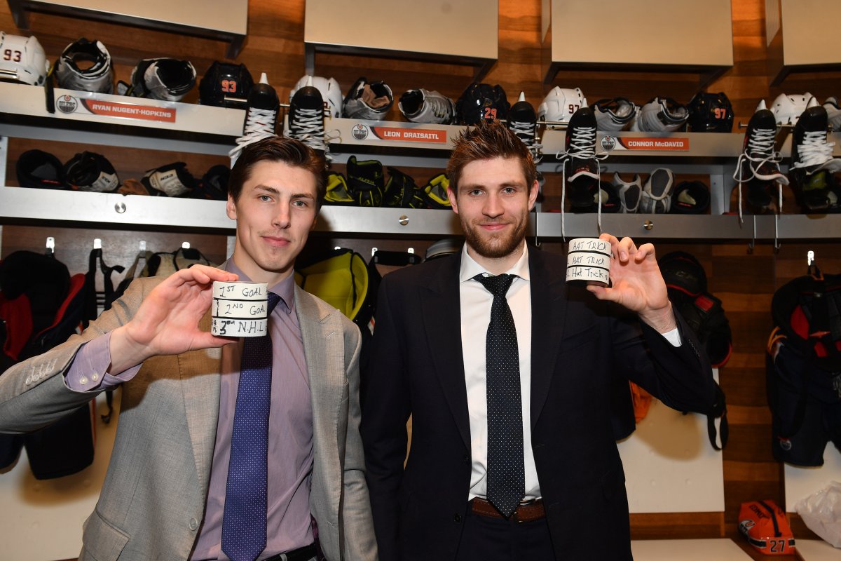 EDMONTON, AB - MARCH 26: Edmonton Oilers center Ryan Nugent-Hopkins (93) and Edmonton Oilers center Leon Draisaitl (29) display their hat trick pucks in the dressing room after a game against the Los Angeles Kings on March 26, 2019 at Rogers Place in Edmonton, Alberta, Canada. (Photo by Andy Devlin/NHLI via Getty Images).