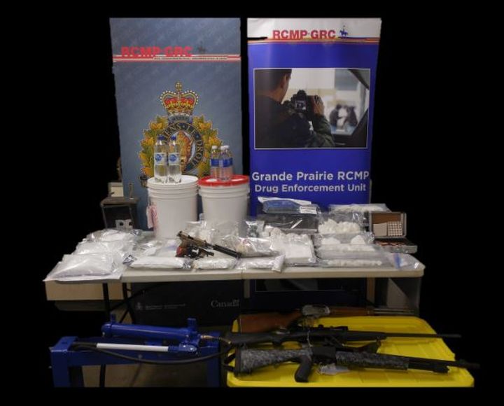 A photo of drugs and weapons seized by police in Grande Prairie, Alta., and Wembley, Alta., on March 17, 2019.