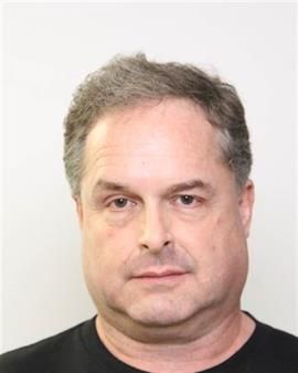 Mark Brookes, 53, is facing several charges in connection to alleged groping incidents at an Edmonton pool, March 27, 2019. 