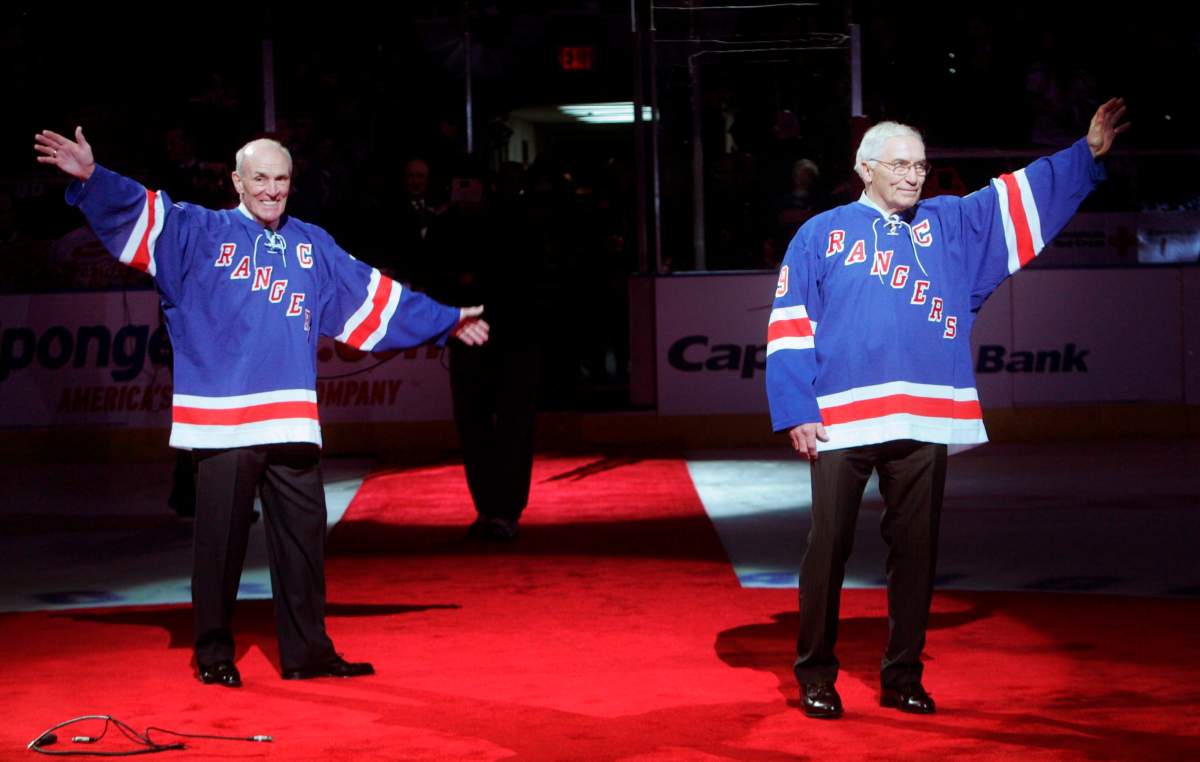 Former New York Rangers Andy Bathgate, right, and Harry Howell wave to fans after their numbers were retired in a ceremony before an NHL hockey game between the Rangers and the Toronto Maple Leafs on Sunday, Feb. 22, 2009, at Madison Square Garden in New York.