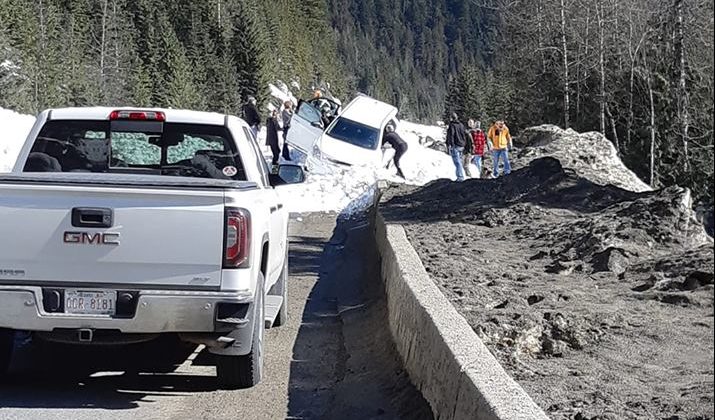A vehicle in an avalanche path on Highway 1 on Sunday.