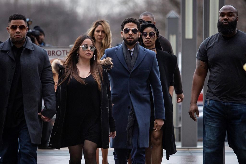 'Empire' actor Jussie Smollett, center, arrives at the Leighton Criminal Court Building for his hearing on Thursday, March 14, 2019, in Chicago.