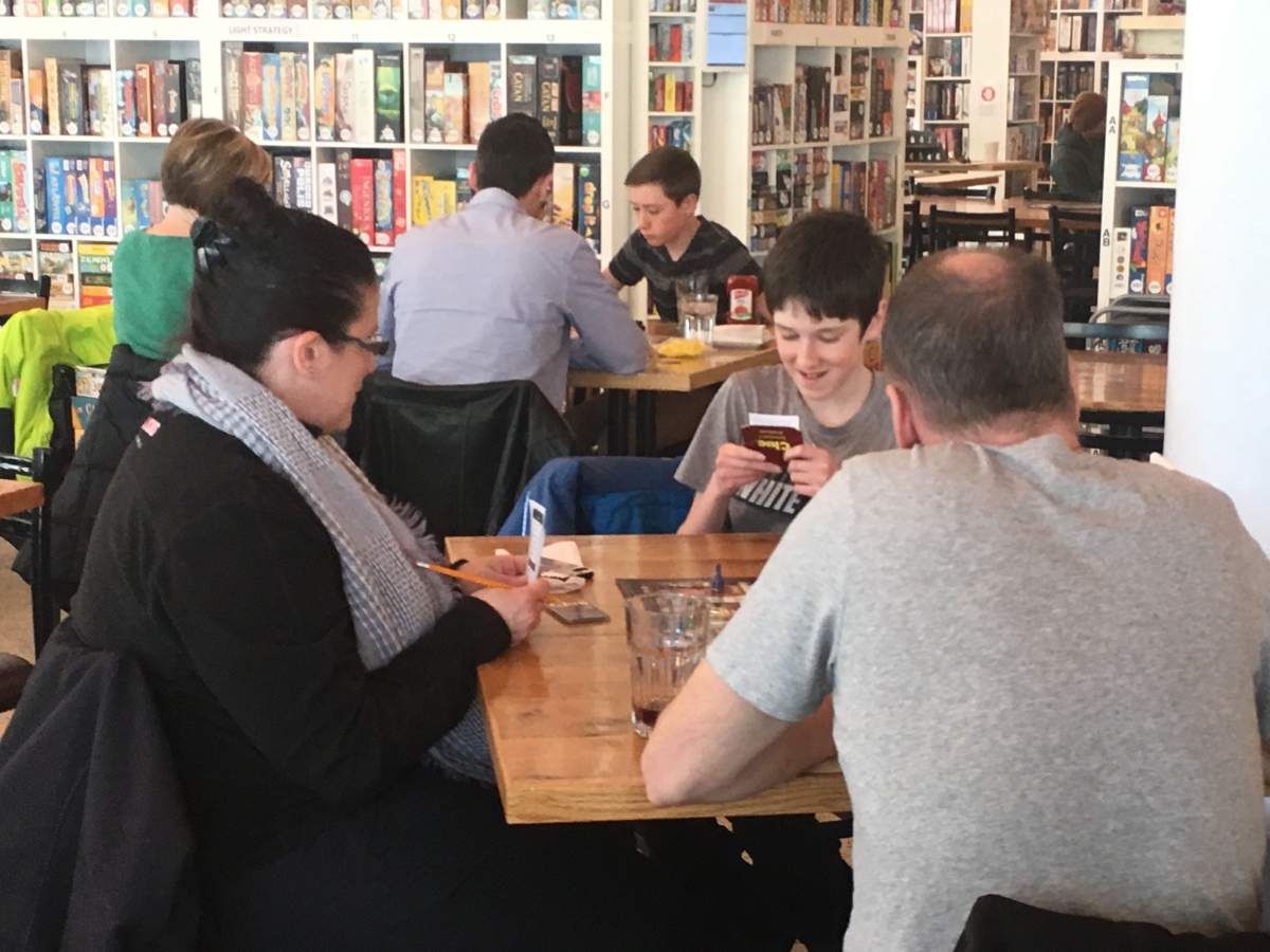 A family enjoying an afternoon of board games at Winnipeg’s Across The Board Game Café.