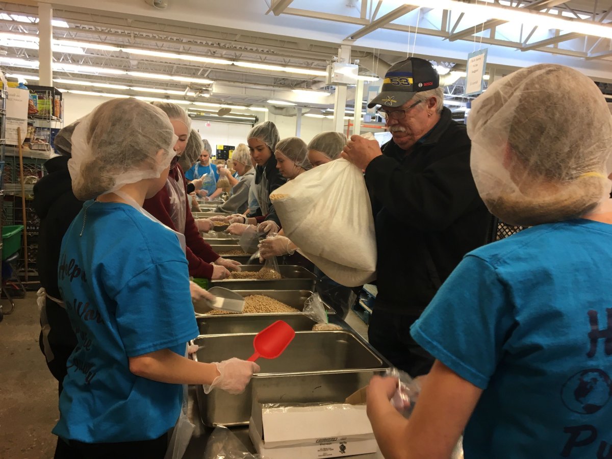 Students sort through beans at Winnipeg Harvest.