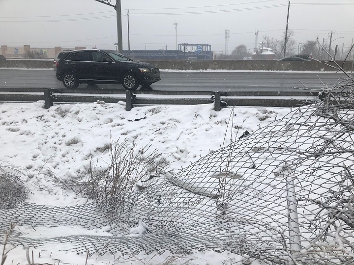 It is believed the car smashed through this fence and went onto the highway.