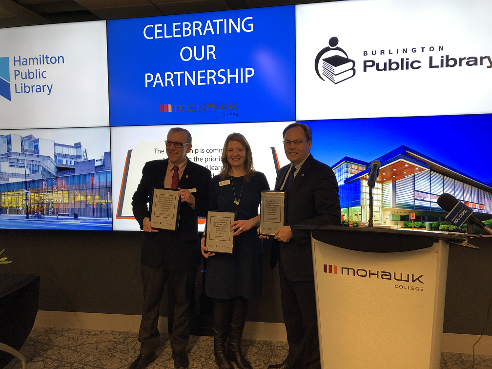 (From left to right) HPL CEO Paul Takala, BPL CEO Lita Barrie and Mohawk College President Ron McKerlie pose for photos after signing an agreement to commit to increasing community access to their resources and programs.