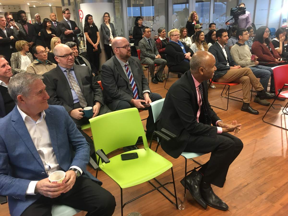 Federal Immigration Minister Ahmed Hussen and Mayor Mike O’Brien listen to Matt DeCourcey’s speech on immigration.