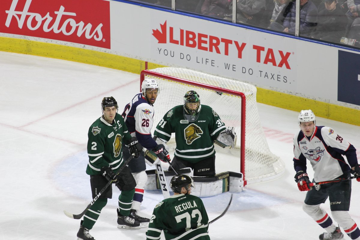 London, Ont - London goalie Jordan Kooy (31) looks on with defenceman Evan Bouchard (2) and Alec Regula (72) help to fend off a Windsor attack around the London net from Cole Purboo (26) and Curtis Douglas of the Spitfires in a 4-3 Game 1 win by the Knights to begin the 2019 OHL post-season.