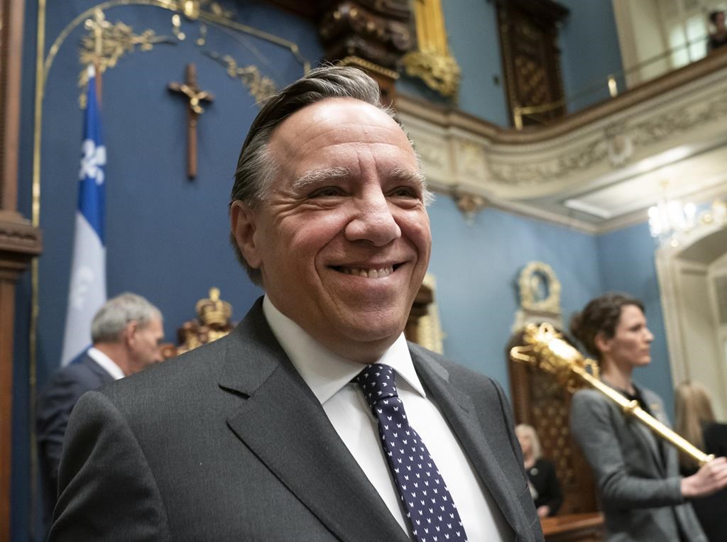 In this March 2019 file photo Quebec Premier Francois Legault walks in as his government is about to table a legislation on laicity of the state, Thursday, March 28, 2019 at the legislature in Quebec City. THE CANADIAN PRESS/Jacques Boissinot.