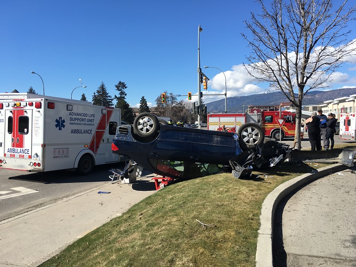 Emergency crews attend a car on its roof along Harvey Avenue after what witnesses say was a hit-and-run accident on Wednesday.