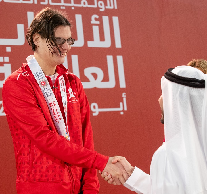Kelsey Wyse of Kelowna shakes hands with a dignitary at the Special Olympics World Games.