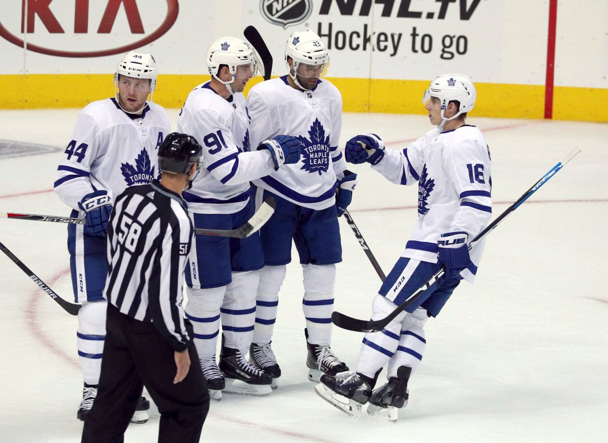 Toronto Maple Leafs Morgan Rielly (44), John Tavares (91), Nazem Kadri (43), and Mitchell Marner (16) celebrate a goal by Tavares against the Dallas Stars in the second period of an NHL hockey game Tuesday, Oct. 9, 2018, in Dallas.