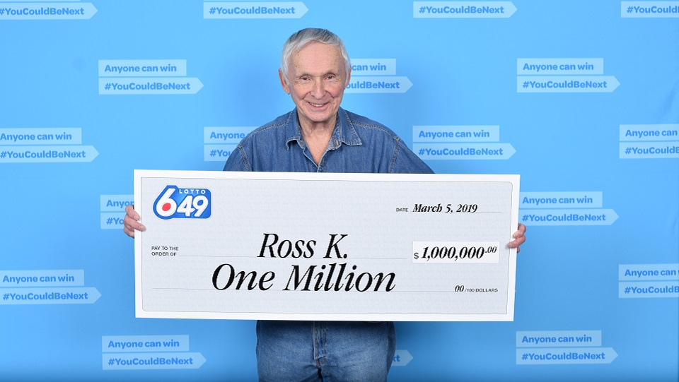 Kelowna's Ross Kulak collects his $1 million cheque after winning in a 6/49 lotto draw.