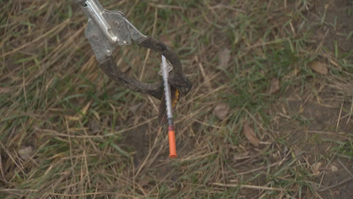 Crews pick up a discarded needle while cleaning up a Vernon homeless camp in 2016. The Greater Vernon Chamber of Commerce says an overdose prevention site in the city is a good idea, but it should be located near the hospital, not the downtown core.