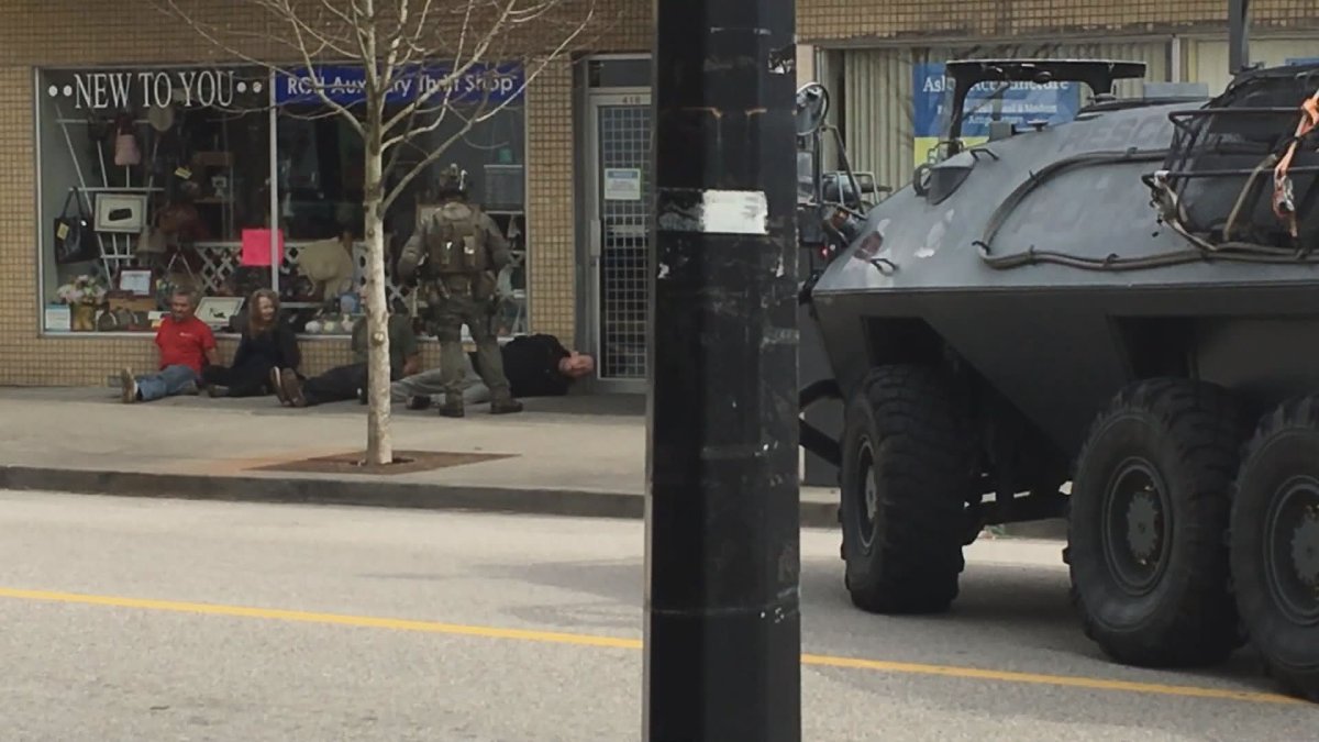 An armoured vehicle and member of the Lower Mainland District ERT are seen in New Westminster on Monday. 