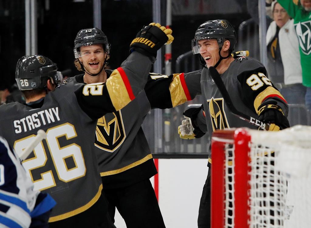 Vegas Golden Knights left wing Tomas Nosek, right, celebrates after scoring against the Winnipeg Jets during the second period of an NHL hockey game Thursday, March 21, 2019, in Las Vegas. (AP Photo/John Locher).