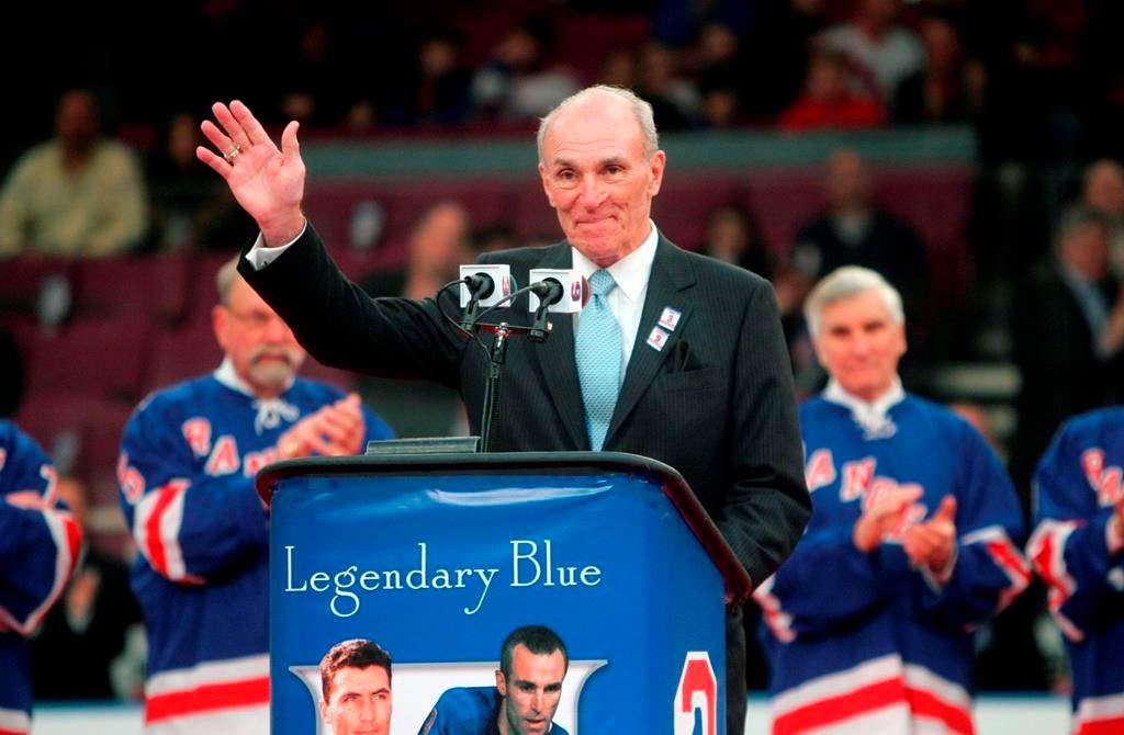 FILE - In this Sunday, Feb. 22, 2009 file photo, Harry Howell waves to the crowd during a ceremony to retire his number before the Ranger's hockey game at Madison Square Garden in New York. NHL Hall of Fame defenseman Harry Howell, who played the most games in the history of New York Rangers, has died. He was 86. Howell died Saturday night, March 9, 2019. Howell played 1,160 games for the Rangers from 1952-69 and had his No. 3 retired by the team. (AP Photo/Seth Wenig, File).