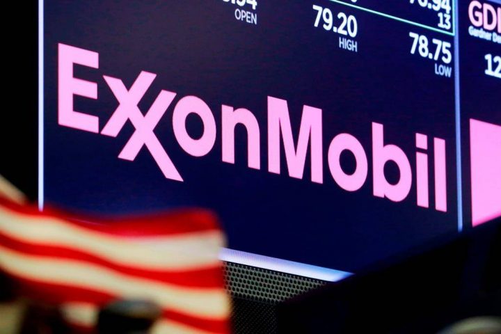 FILE - In this April 23, 2018, file photo, the logo for ExxonMobil appears above a trading post on the floor of the New York Stock Exchange.