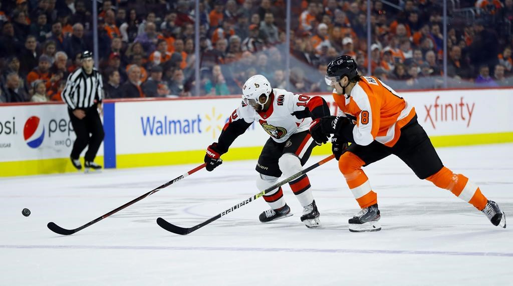 Ottawa Senators' Anthony Duclair, left, and Philadelphia Flyers' Robert Hagg chase after the puck during the first period of an NHL hockey game, Monday, March 11, 2019, in Philadelphia.