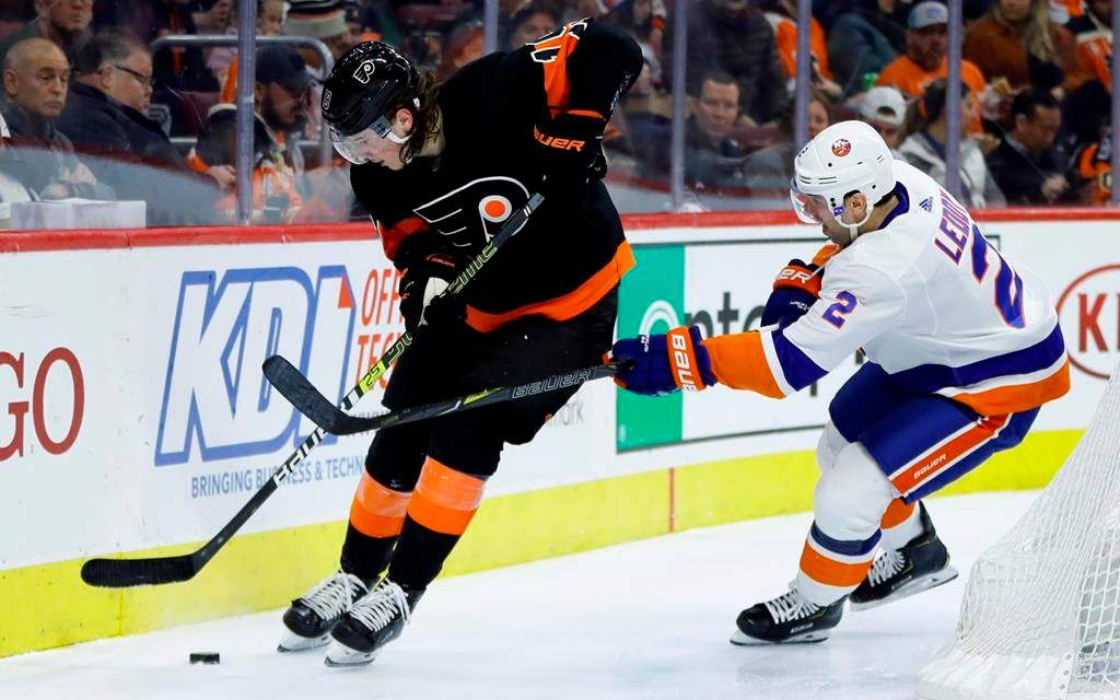 Philadelphia Flyers' Nolan Patrick, left, tries to keep the puck away from New York Islanders' Nick Leddy during the second period of an NHL hockey game, Saturday, March 23, 2019, in Philadelphia. (AP Photo/Matt Slocum).