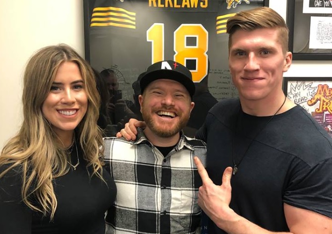 Jenna Walker and Stuart Walker, who make up the country duo The Reklaws, pose for a photo with Country 104 host Matt Weaver. 