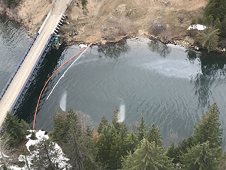 A containment boom and absorbent boom deployed upstream from the confluence of the Salmo and Pend d\’Oreille Rivers in response to a fuel spill Thursday.