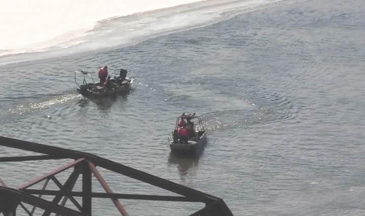 Crews in rescue boats scour the waters of the South Saskatchewan River downstream of the Senator Sid Buckwold Bridge on March 13, 2019.