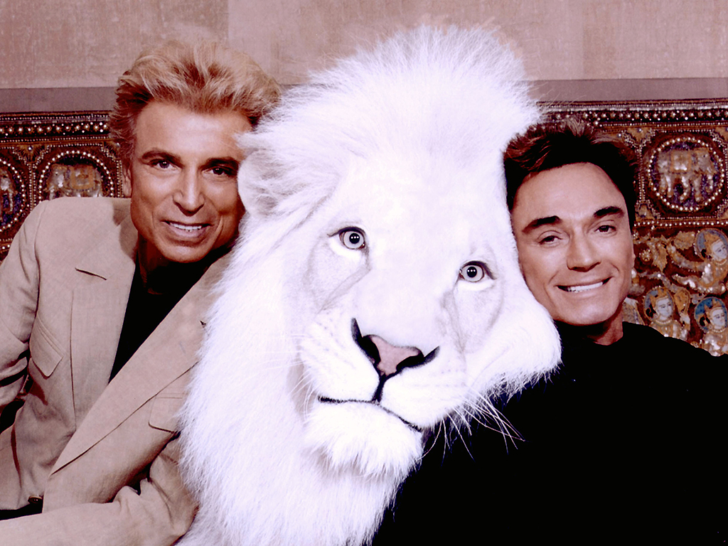 In this handout image provided by the Mirage Resort, Siegfried & Roy pose with Pride, a white lion, in this undated photo.
